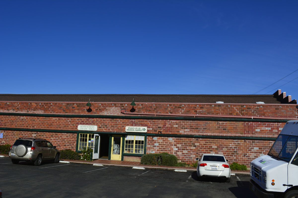 Brick commercial storefronts with new flat roof