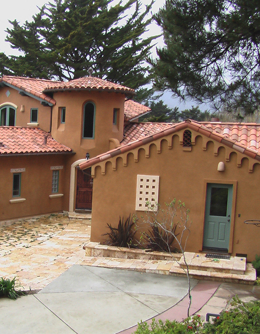 Tuscan-style home with tile roofing